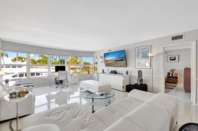 a living room with furniture and large windows