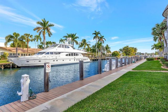 a view of a patio with couches table and chairs and potted plants