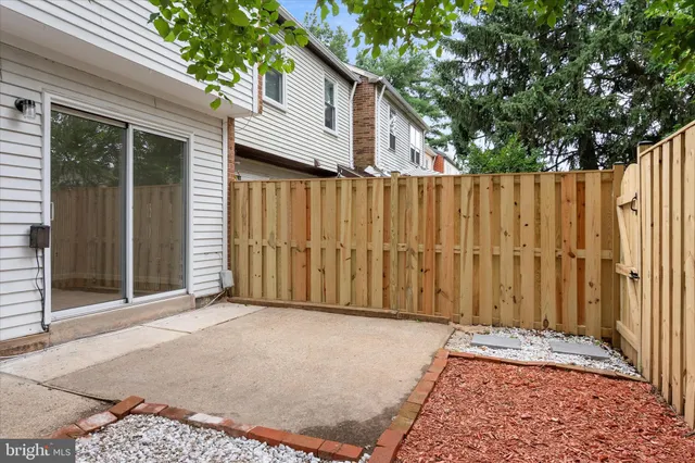 a view of a house with a wooden fence