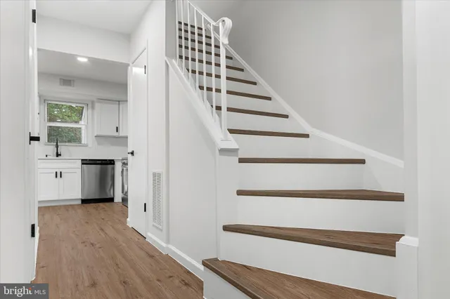 a view of entryway and hall with wooden floor