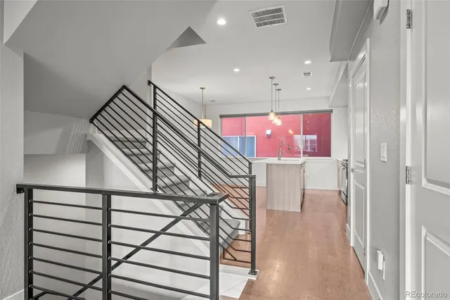 a kitchen with stainless steel appliances granite countertop a sink and a stove