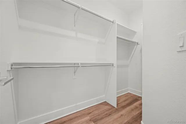 a view of a room with wooden floor