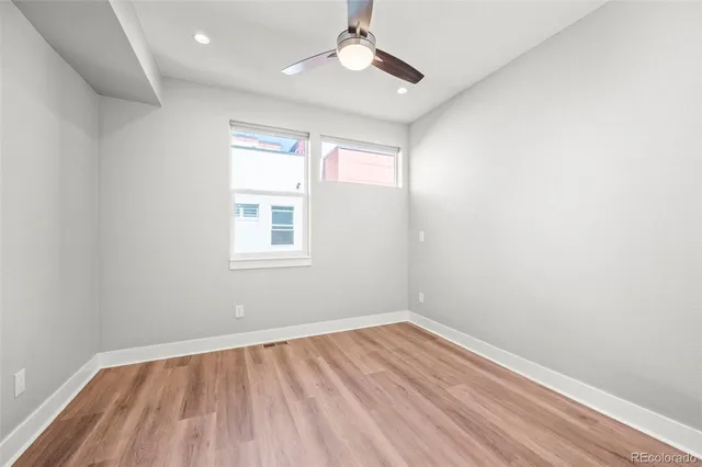 a room with wooden floor and white walls