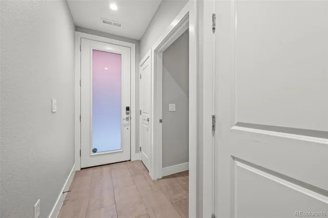 a view of an empty room with a window and closet