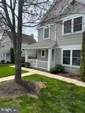 a front view of a house with a yard and green space