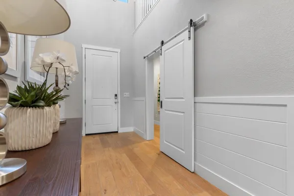 a view of a hallway with wooden floor and staircase