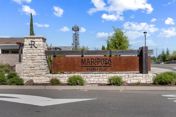 a sign board on the side of a street