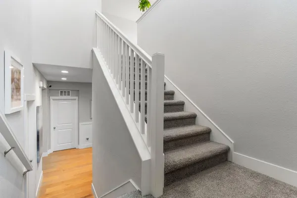 a large kitchen with stainless steel appliances granite countertop a stove a sink a refrigerator a center island and furniture