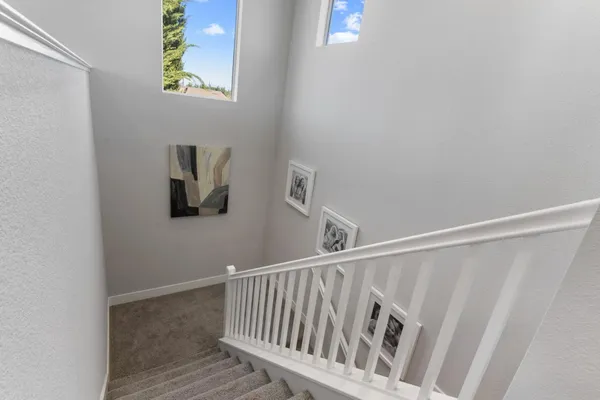 a kitchen with a refrigerator and a stove top oven