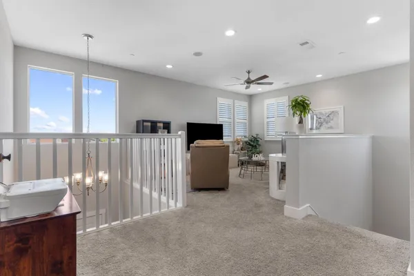 a kitchen with stainless steel appliances granite countertop a sink a stove a refrigerator and white cabinets