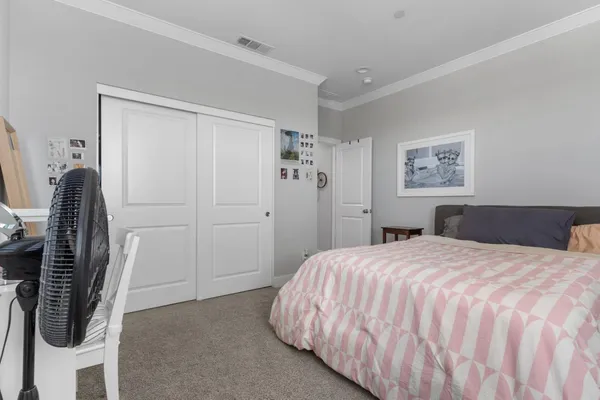 a view of a patio with a table and chairs under an umbrella with potted plants