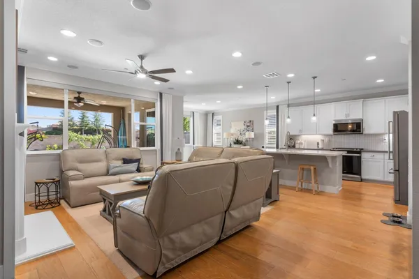 a view of a patio with a table and chairs under an umbrella with potted plants