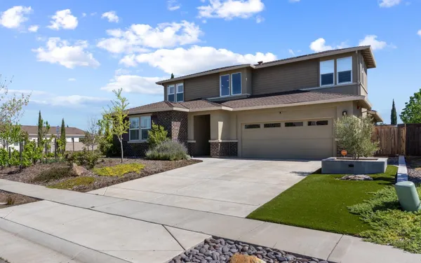 a front view of a house with garden and porch
