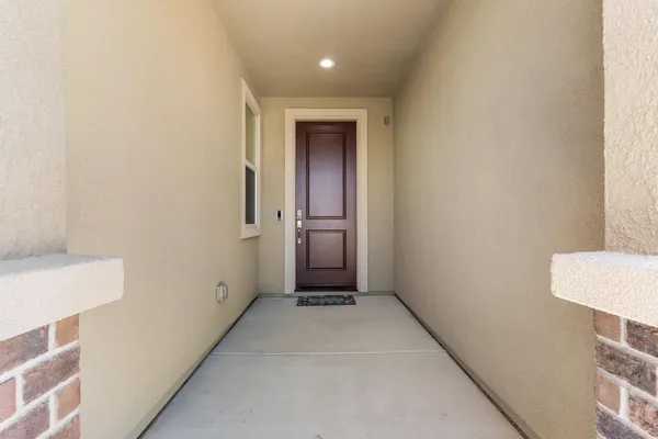 a view of a kitchen with refrigerator and wooden floor