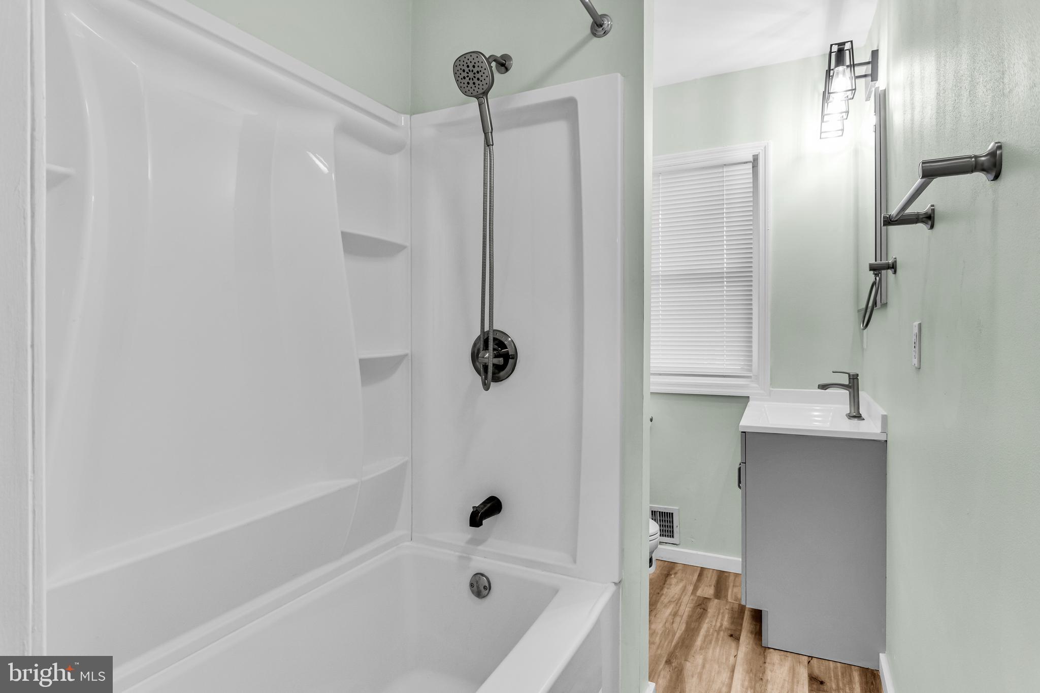 726 South 2nd Street Steelton, PA 17113 - Photo 11 of 25 a bathroom with a bathtub a shower a sink and a toilet