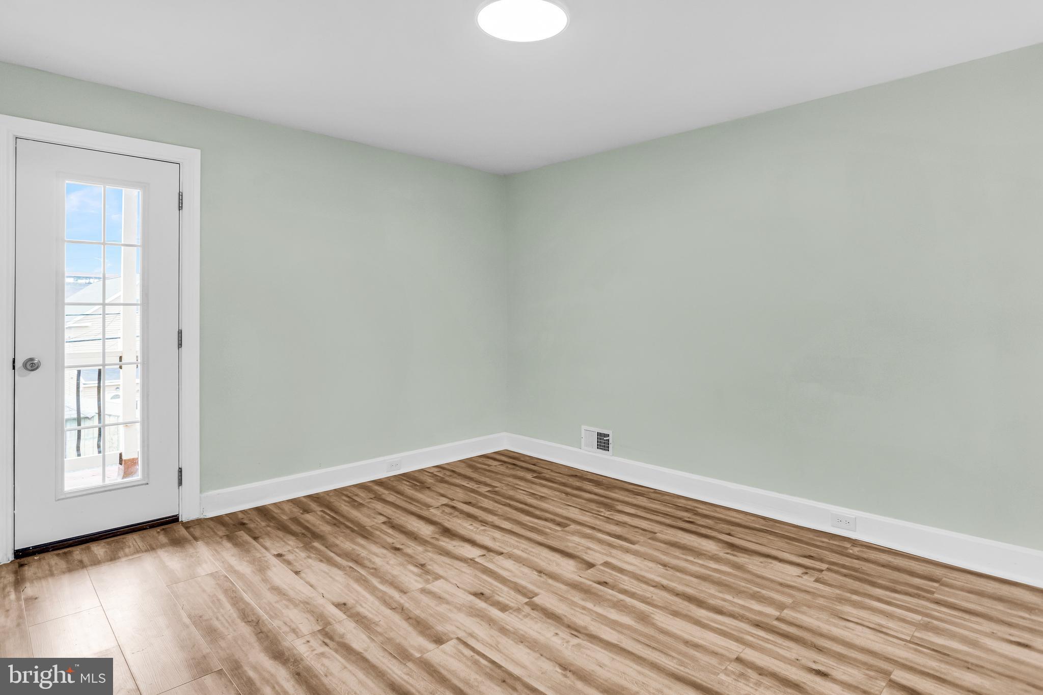 726 South 2nd Street Steelton, PA 17113 - Photo 16 of 25 an empty room with wooden floor and windows