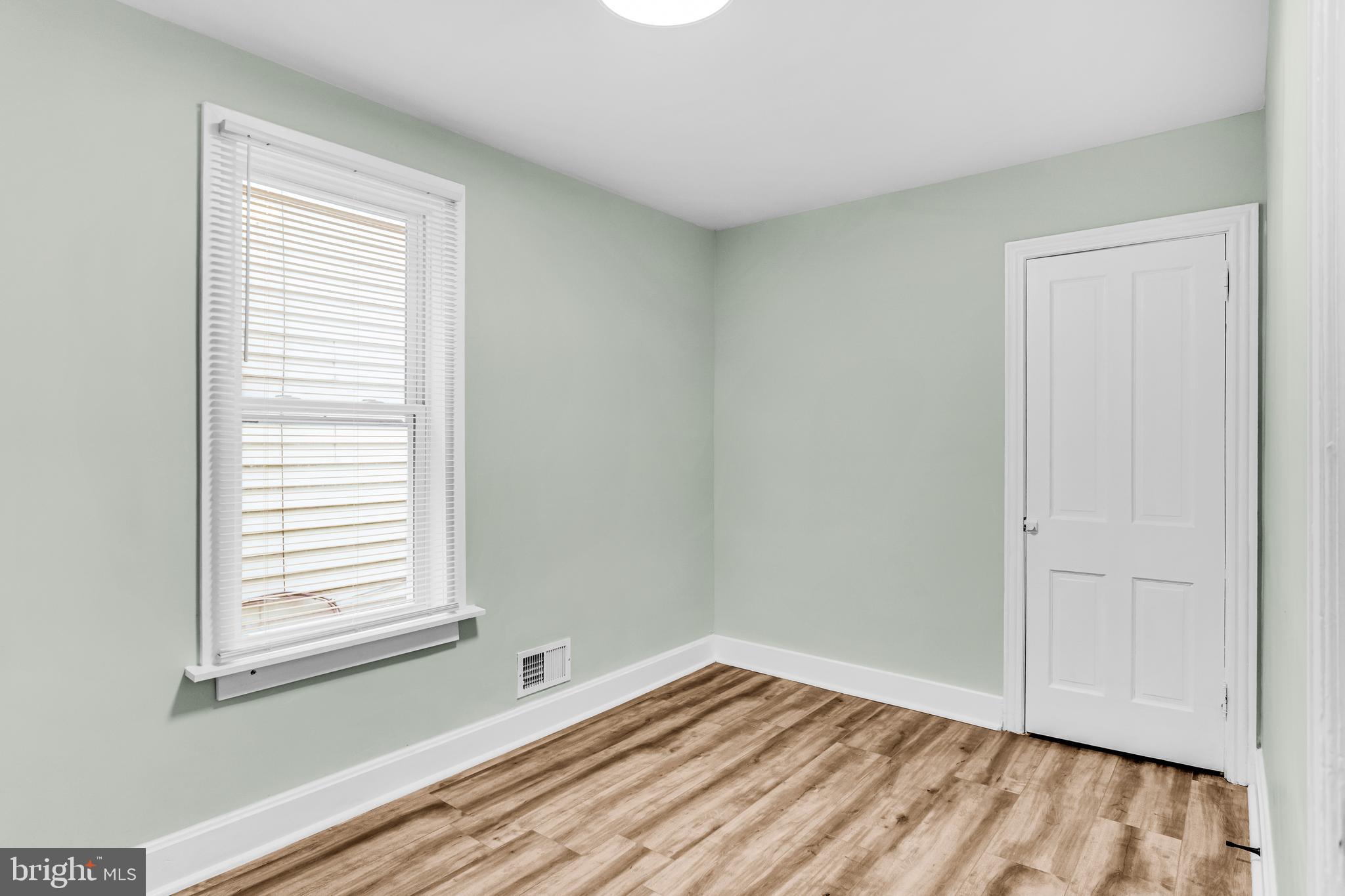 726 South 2nd Street Steelton, PA 17113 - Photo 17 of 25 a view of an empty room with wooden floor and a window