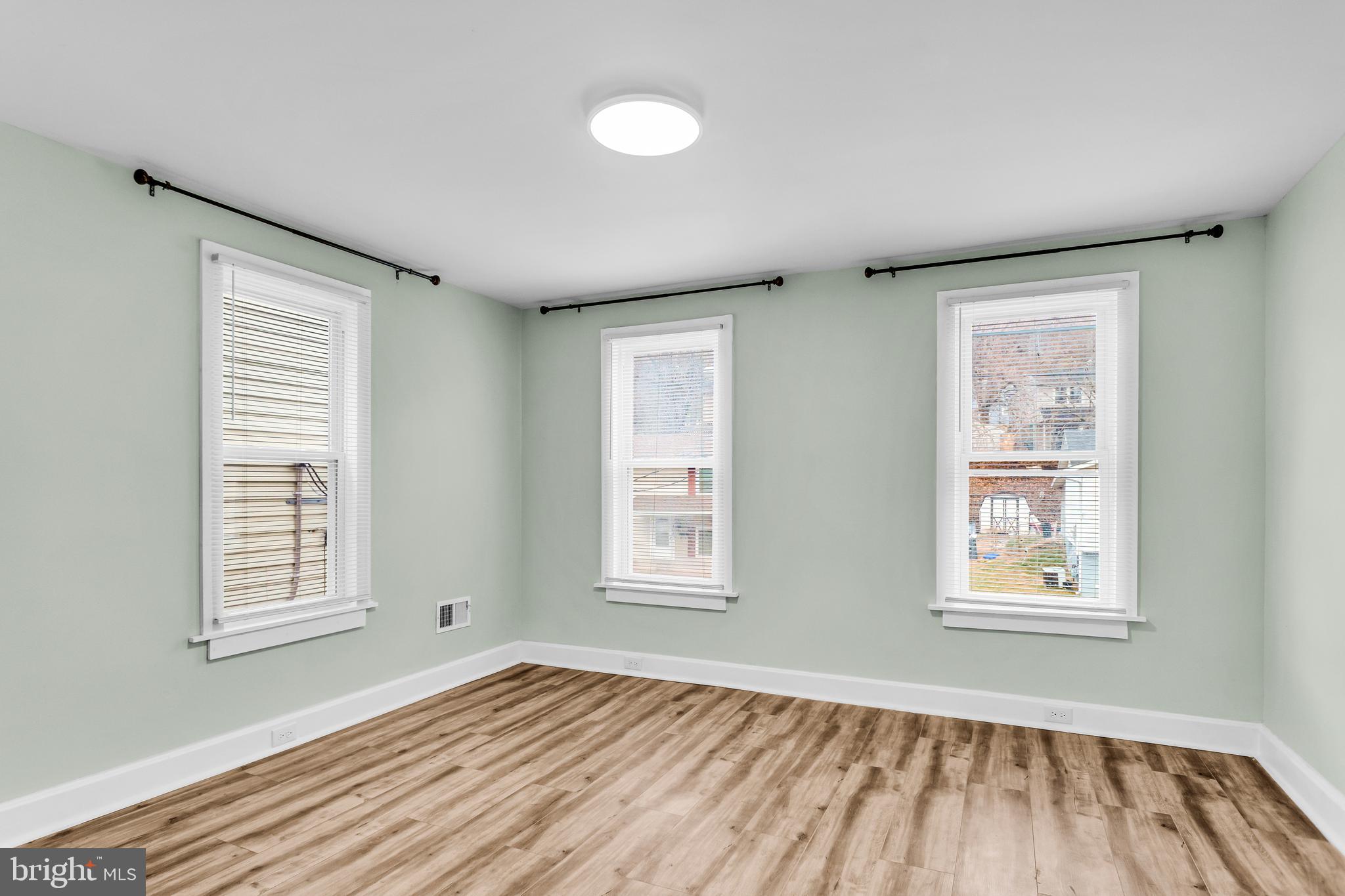 726 South 2nd Street Steelton, PA 17113 - Photo 18 of 25 a view of an empty room with a window and wooden floor