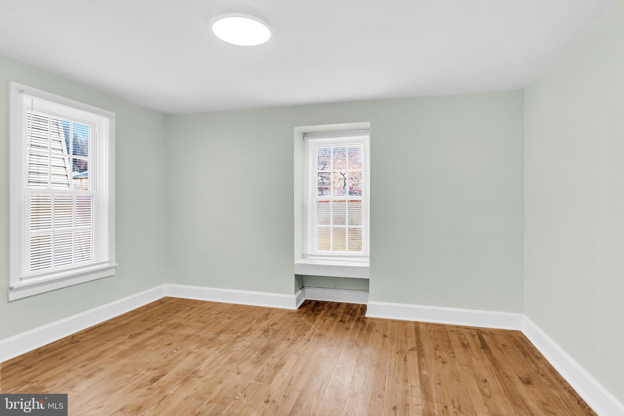726 South 2nd Street Steelton, PA 17113 - Photo 19 of 25 an empty room with wooden floor and windows