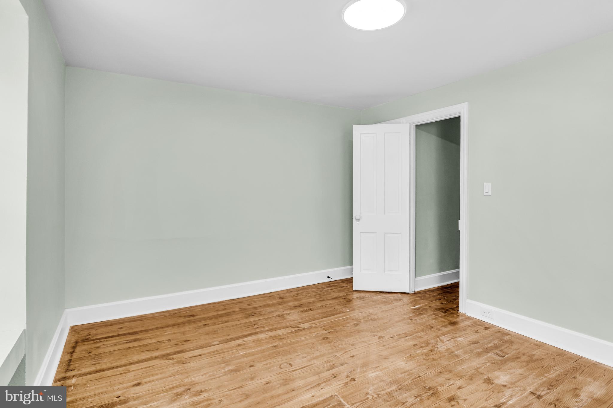 726 South 2nd Street Steelton, PA 17113 - Photo 20 of 25 an empty room with wooden floor and white walls