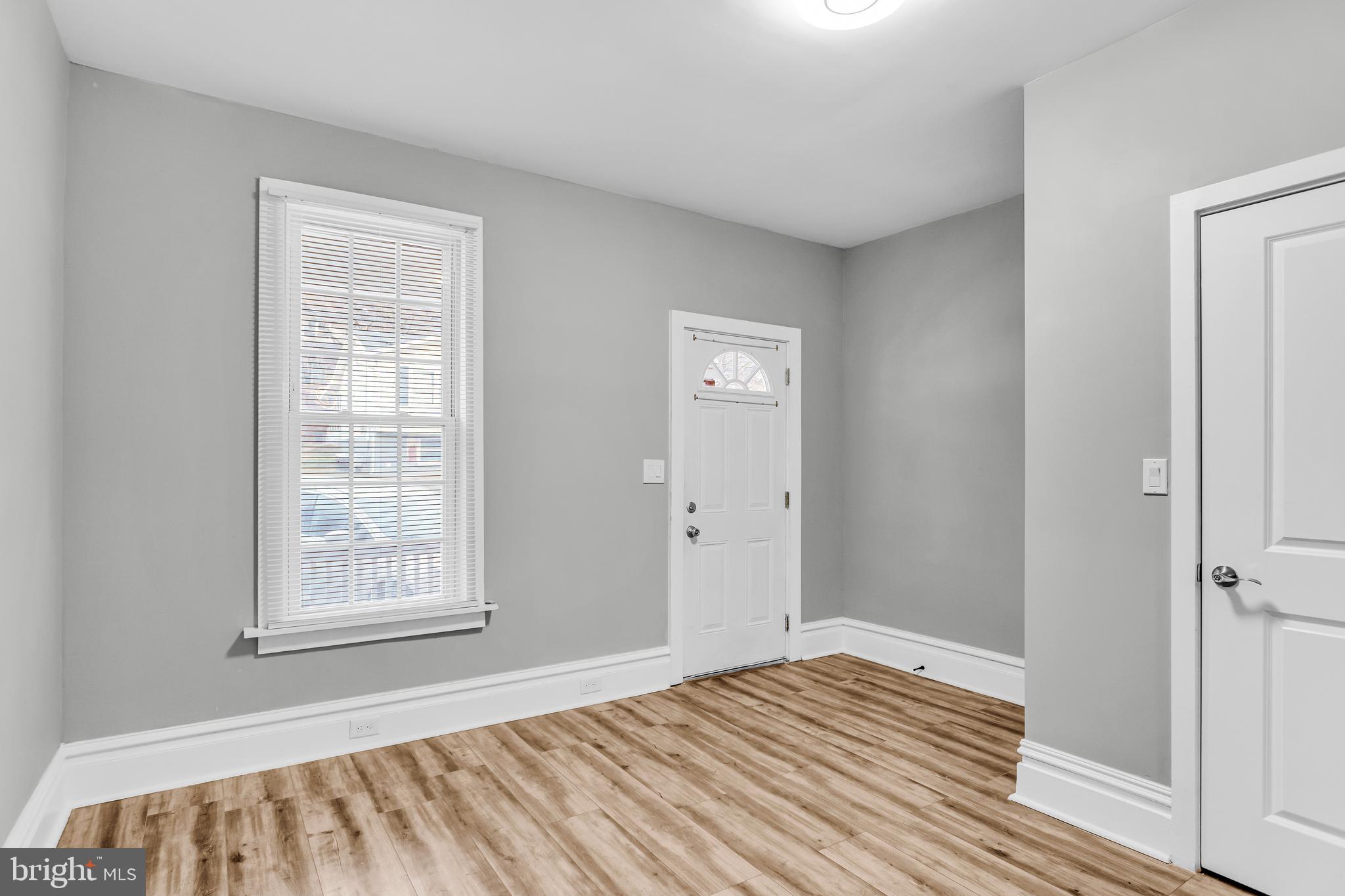 726 South 2nd Street Steelton, PA 17113 - Photo 5 of 25 a view of an empty room with wooden floor and a window