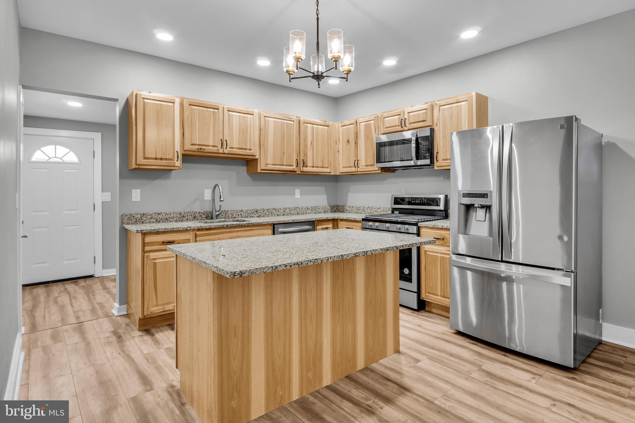 726 South 2nd Street Steelton, PA 17113 - Photo 6 of 25 a kitchen with kitchen island granite countertop stainless steel appliances cabinets a sink and a center island