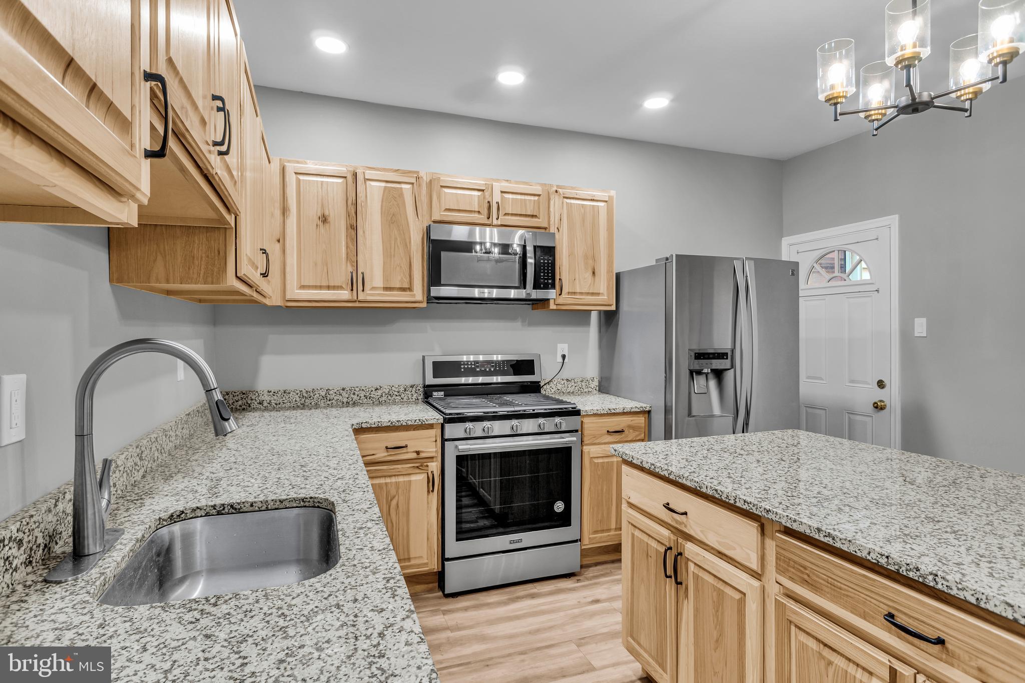726 South 2nd Street Steelton, PA 17113 - Photo 7 of 25 a kitchen with stainless steel appliances granite countertop a sink refrigerator and microwave
