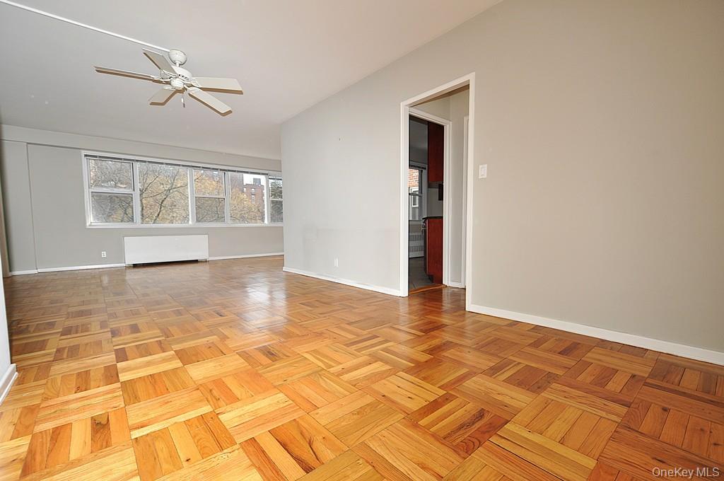 260 Garth Road, Unit 4G5 Scarsdale, NY 10583 - Photo 11 of 48 a view of an empty room with a window and wooden floor