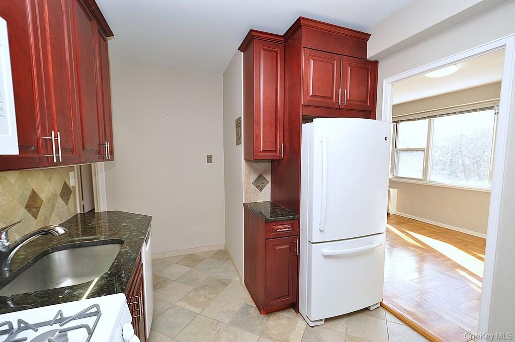 260 Garth Road, Unit 4G5 Scarsdale, NY 10583 - Photo 16 of 48 a kitchen with a refrigerator and a sink