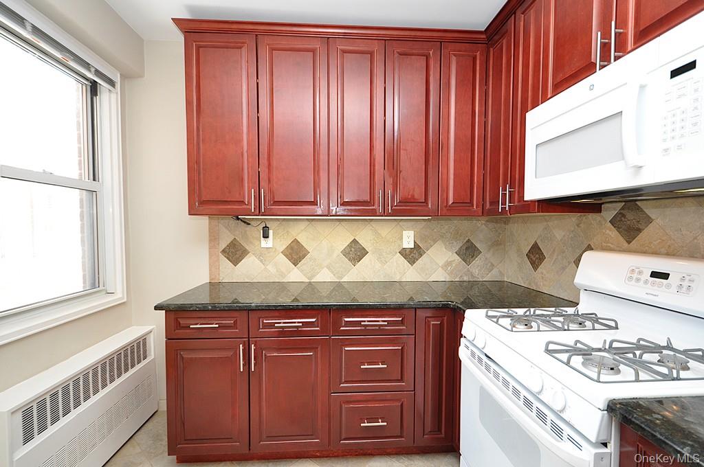 260 Garth Road, Unit 4G5 Scarsdale, NY 10583 - Photo 17 of 48 a stove top oven sitting inside of a kitchen