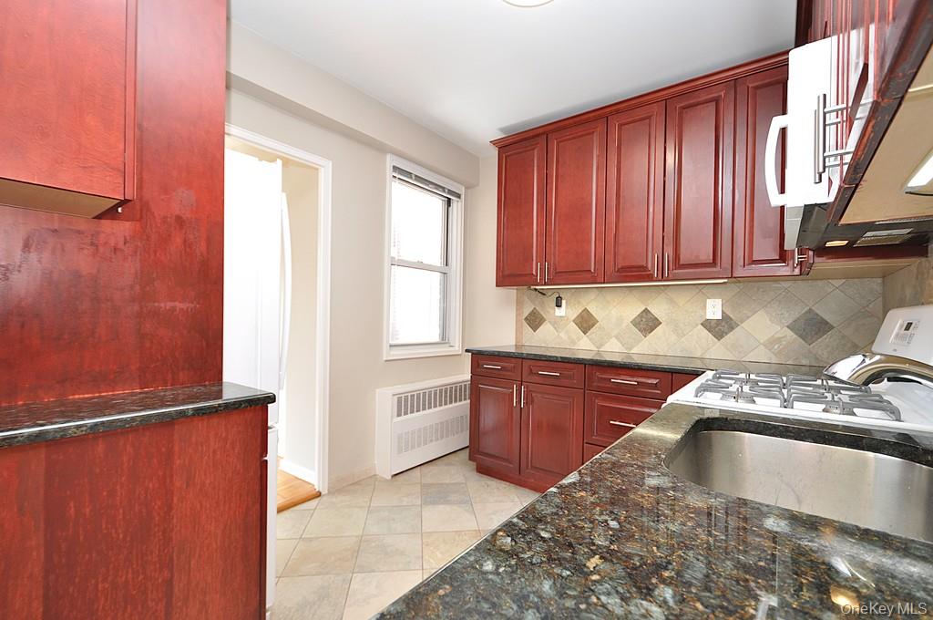 260 Garth Road, Unit 4G5 Scarsdale, NY 10583 - Photo 20 of 48 a kitchen with granite countertop stainless steel appliances a refrigerator and a sink