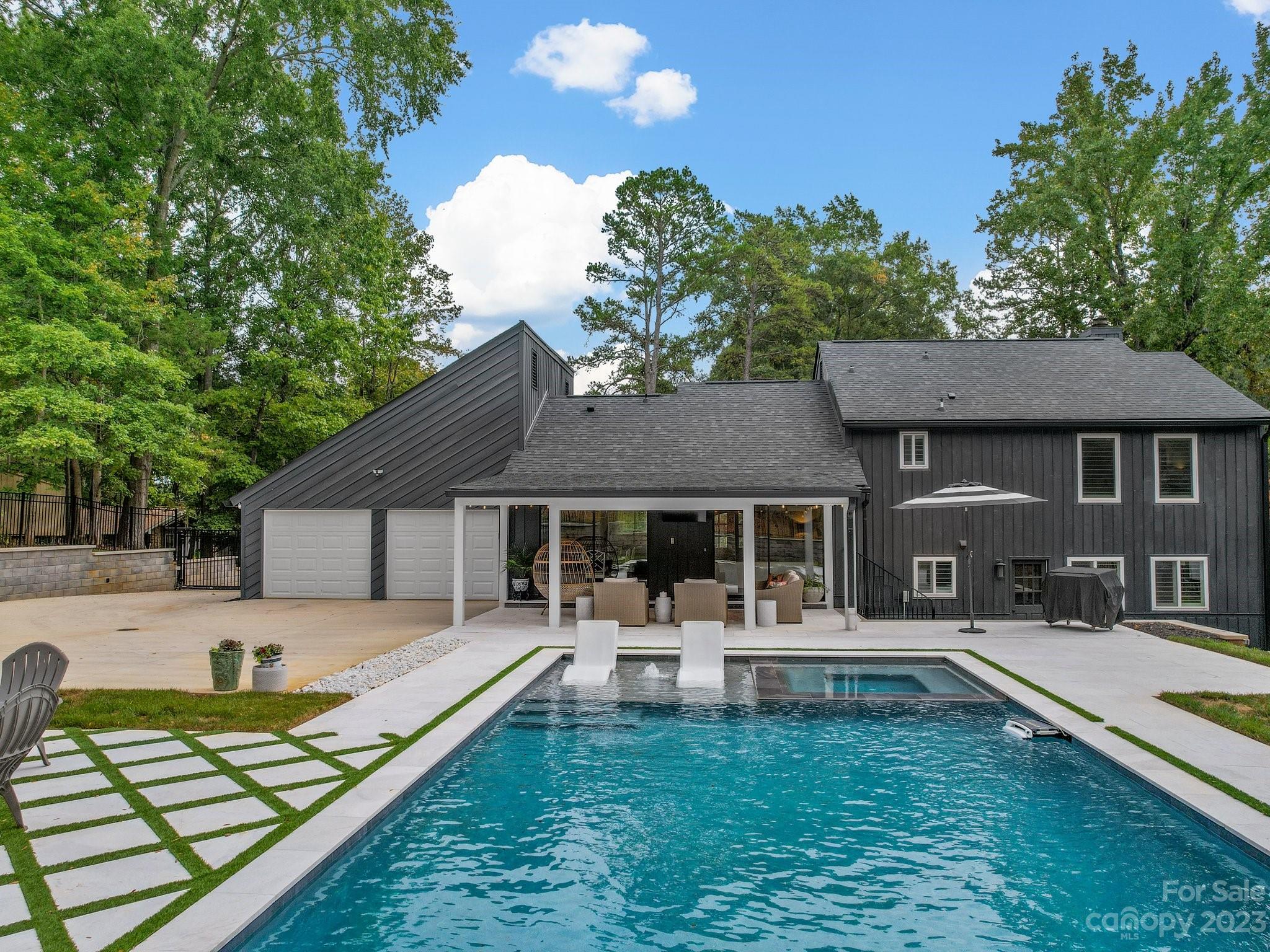 4516 Rounding Run Road Charlotte, NC 28277 - Photo 1 of 33 a swimming pool view with a seating space and a garden view