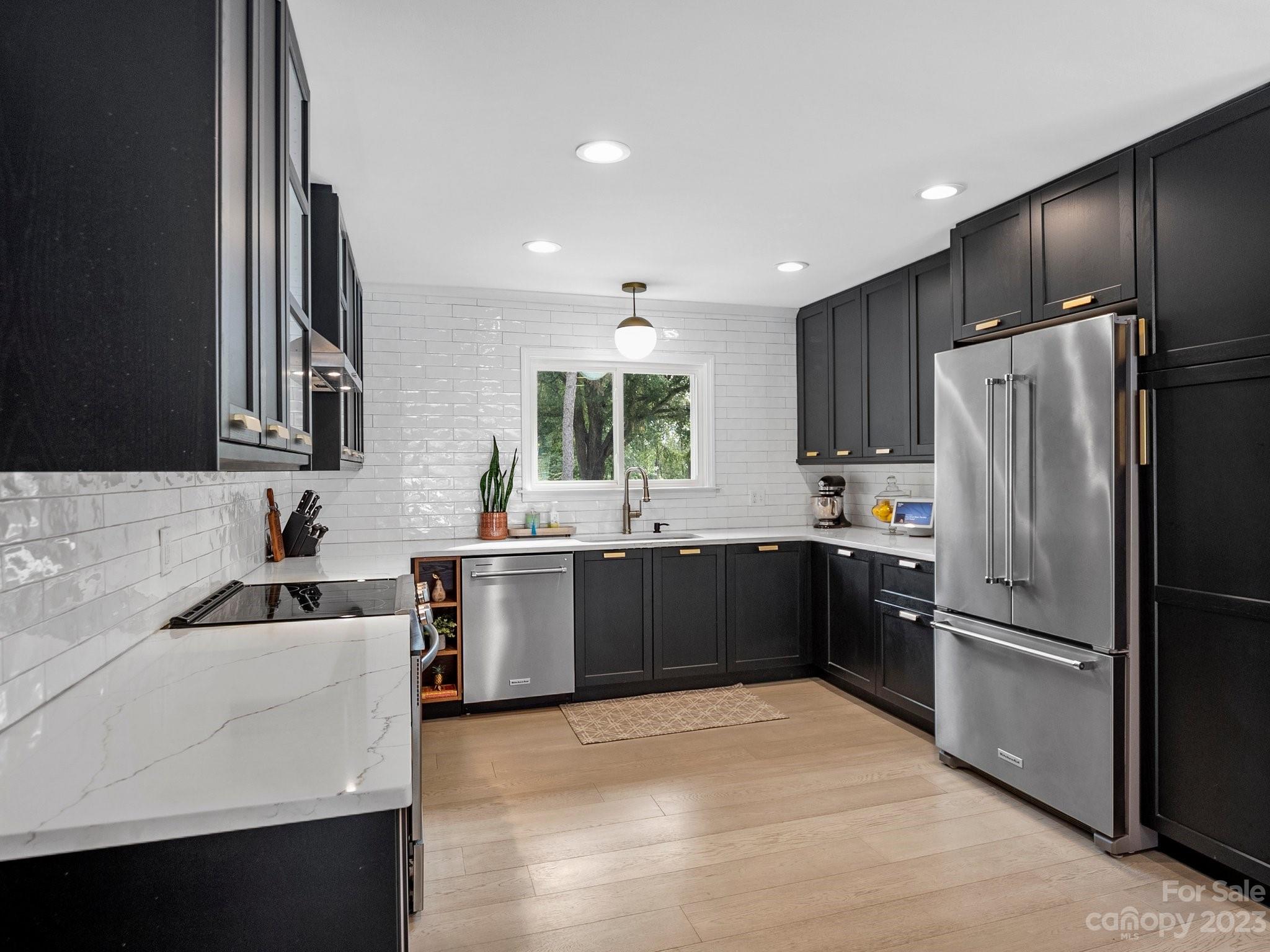 4516 Rounding Run Road Charlotte, NC 28277 - Photo 11 of 33 a kitchen with a refrigerator and a sink
