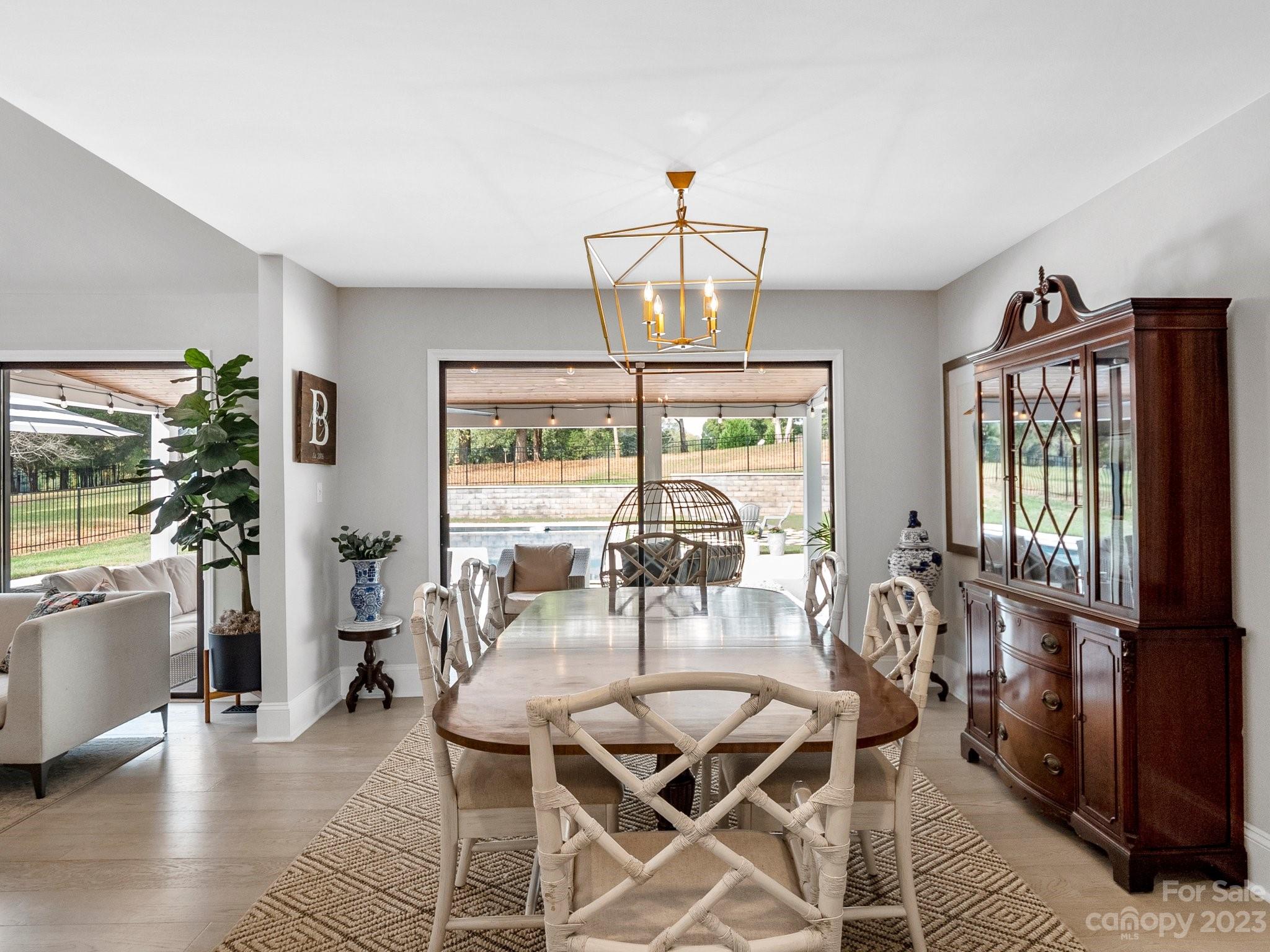 4516 Rounding Run Road Charlotte, NC 28277 - Photo 12 of 33 a dining room with furniture a chandelier and wooden floor