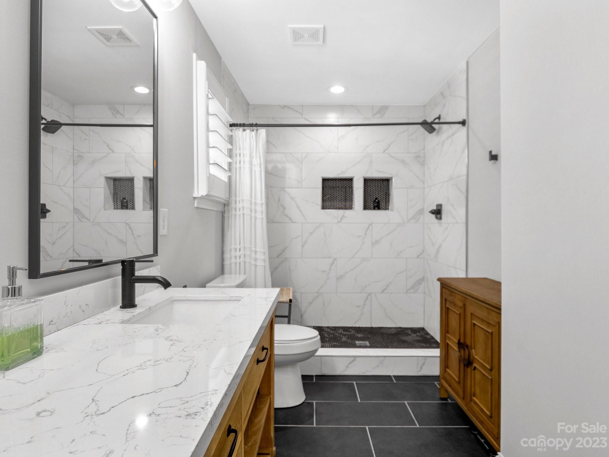 4516 Rounding Run Road Charlotte, NC 28277 - Photo 17 of 33 a bathroom with a sink a toilet and shower