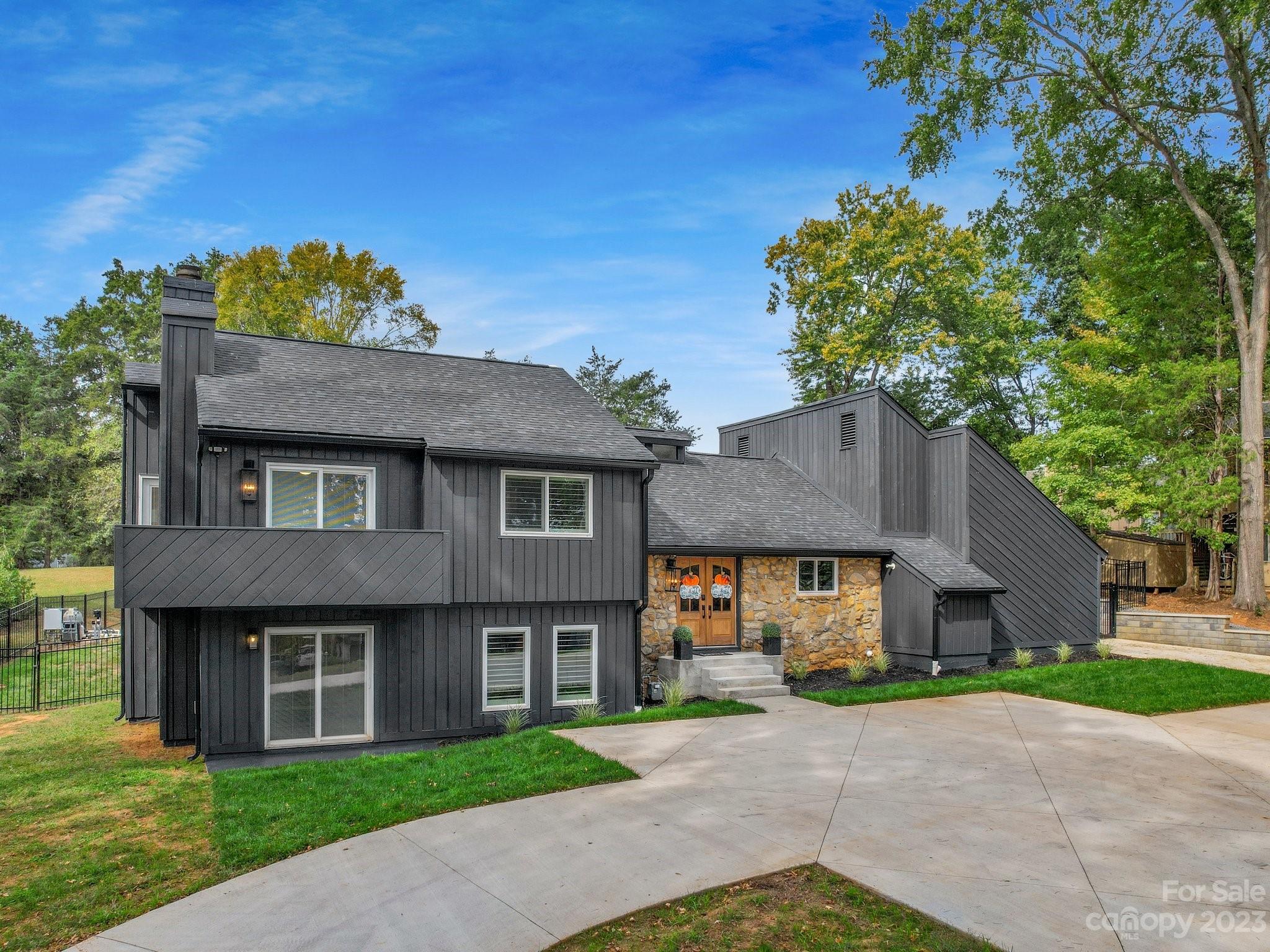 4516 Rounding Run Road Charlotte, NC 28277 - Photo 2 of 33 a front view of a house with a yard and a garage