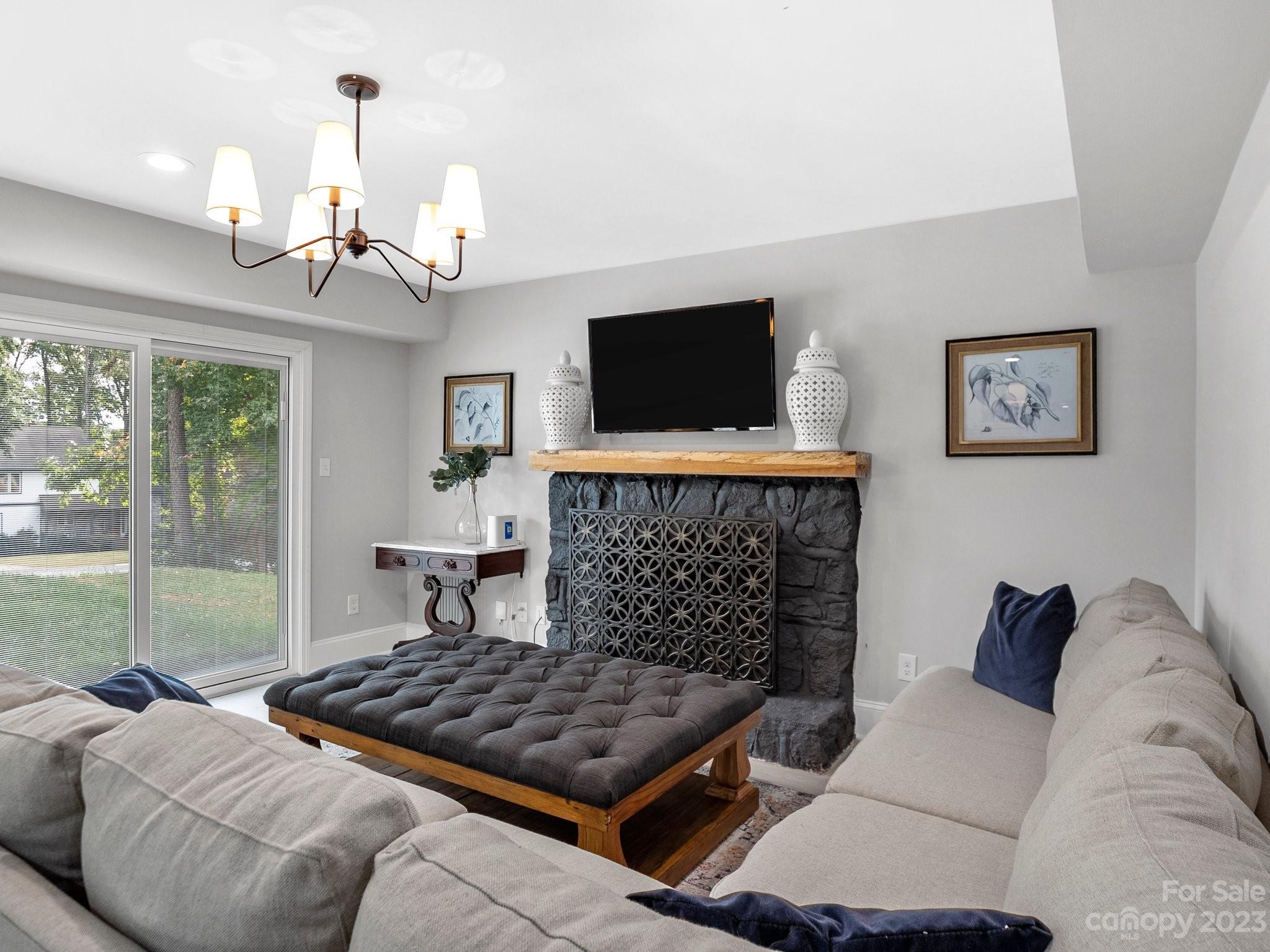 4516 Rounding Run Road Charlotte, NC 28277 - Photo 21 of 33 a living room with furniture a flat screen tv and a fireplace