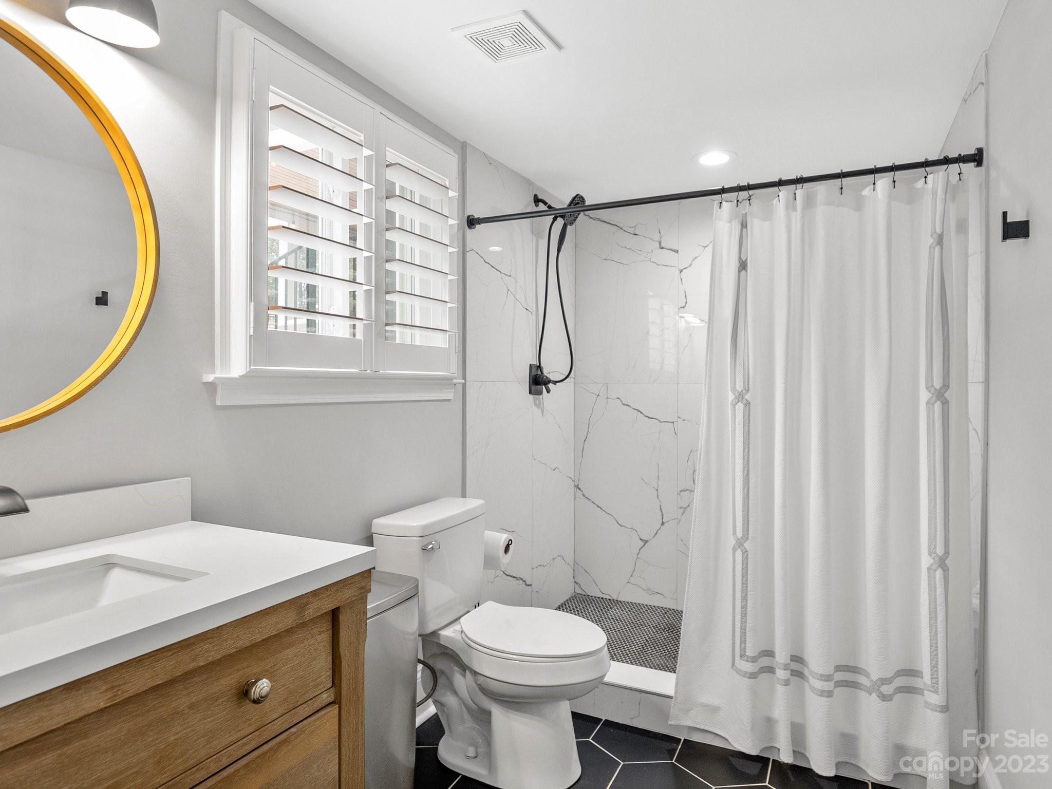 4516 Rounding Run Road Charlotte, NC 28277 - Photo 24 of 33 a bathroom with a sink a toilet and shower