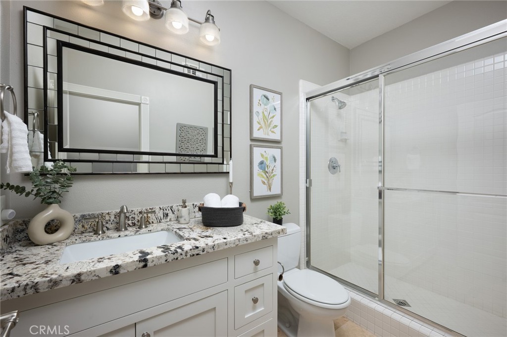 12 Serna Rancho Santa Margarita, CA 92688 - Photo 14 of 75 a bathroom with a granite countertop sink mirror vanity and toilet