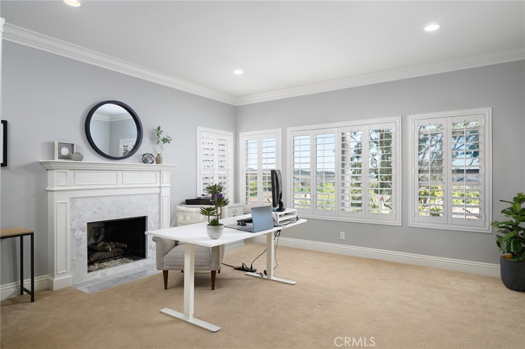 12 Serna Rancho Santa Margarita, CA 92688 - Photo 22 of 75 a living room with furniture a fireplace and a large window