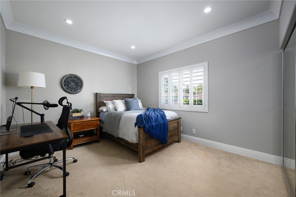 12 Serna Rancho Santa Margarita, CA 92688 - Photo 27 of 75 a spacious bedroom with a bed and a table in it