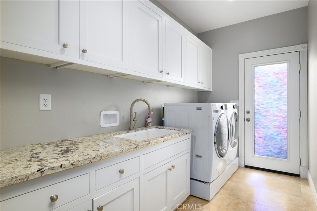 12 Serna Rancho Santa Margarita, CA 92688 - Photo 29 of 75 a utility room with granite countertop white cabinets and sink