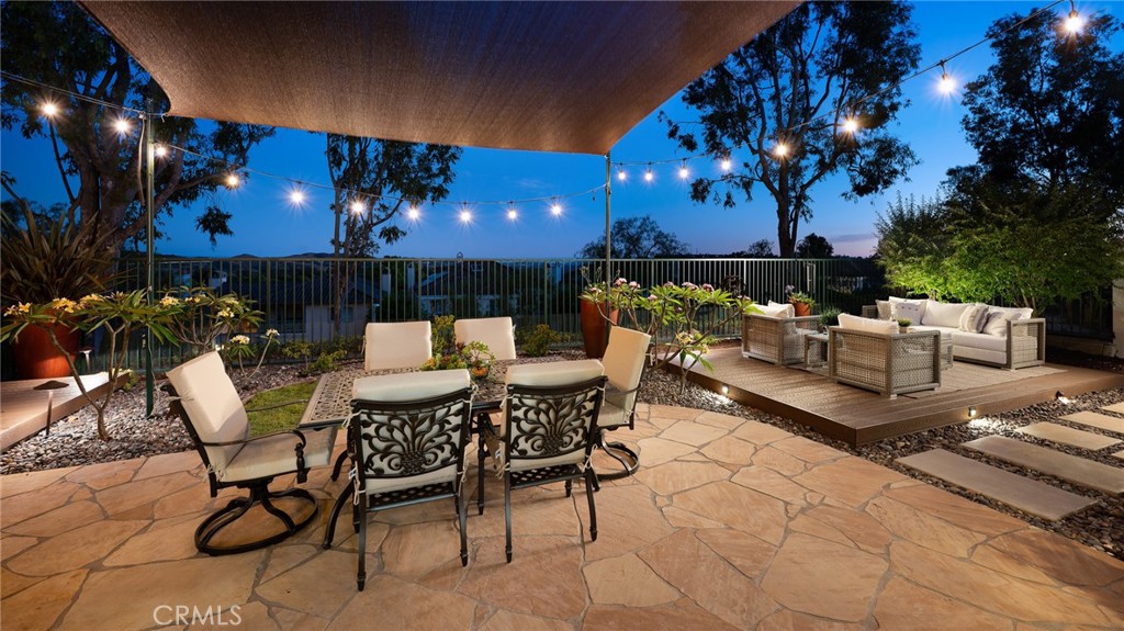 12 Serna Rancho Santa Margarita, CA 92688 - Photo 45 of 75 a view of a patio with a dining table and chairs with a fire pit and a fire pit