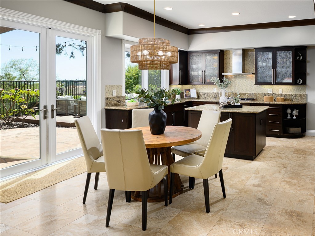 12 Serna Rancho Santa Margarita, CA 92688 - Photo 7 of 75 a kitchen with a dining table chairs and granite counter tops