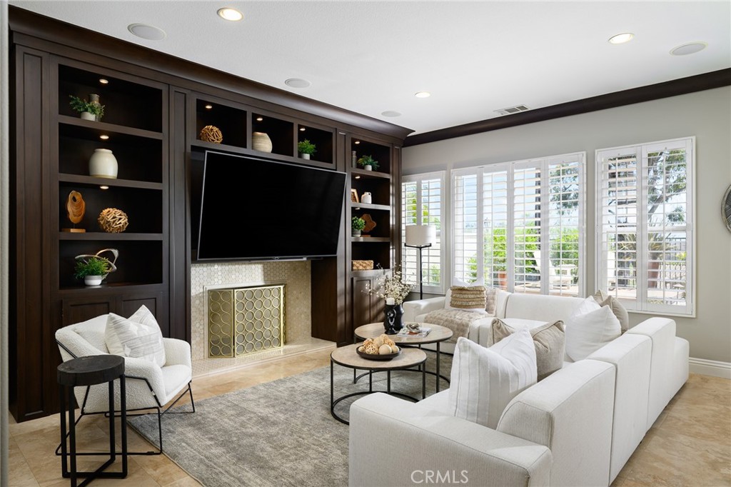 12 Serna Rancho Santa Margarita, CA 92688 - Photo 8 of 75 a living room with furniture a fireplace and a flat screen tv