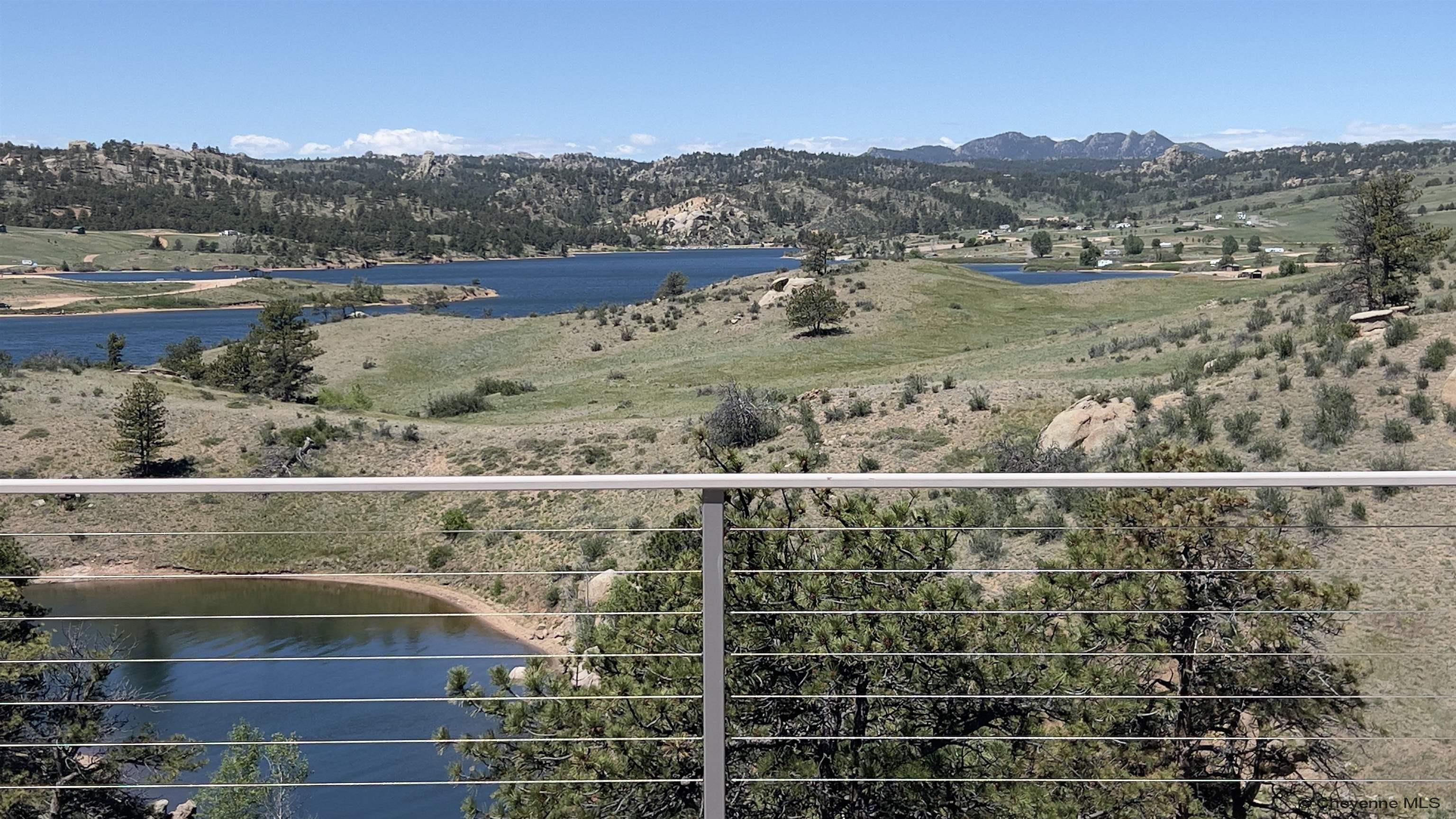 393 Happy Jack Road Cheyenne, WY 82009 - Photo 2 of 34 On the Patio of the cliff houses you have the greatest view in Laramie County. Overlooking your dock and Curt Gowdy state park you have views that are epic everyday in any weather. Space to easily entertain 100 people and more this is a spot to witness.
