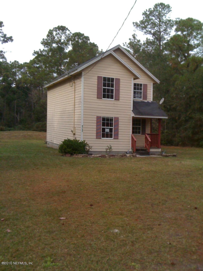 97155 Chester River Road Yulee, FL 32097 - Photo 1 of 4 a view of a house with a yard
