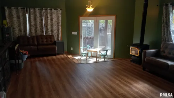 a view of a livingroom with wooden floor and furniture
