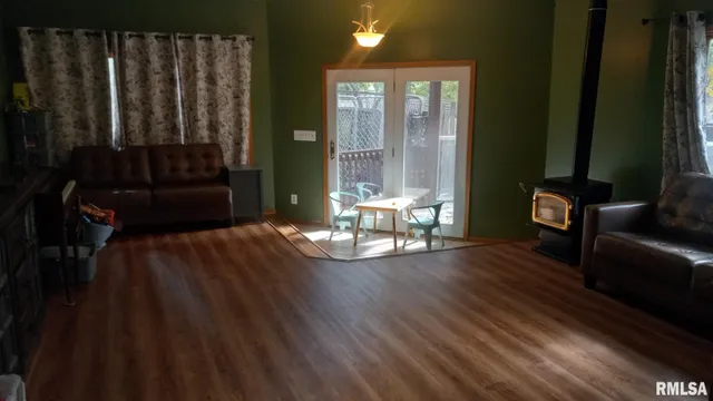 a view of a livingroom with wooden floor and furniture