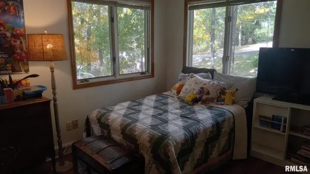 a bed sitting in a bedroom next to a window
